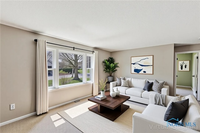242 E Yates Ave, Findlay, OH 45840 - living room with light carpet, baseboards, and a textured ceiling
