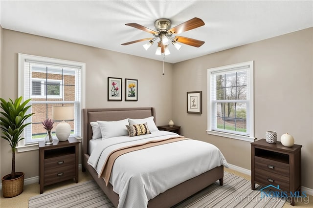 242 E Yates Ave, Findlay, OH 45840 - bedroom with baseboards, light carpet, and ceiling fan