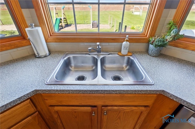 room details with a sink, brown cabinets, and tasteful backsplash