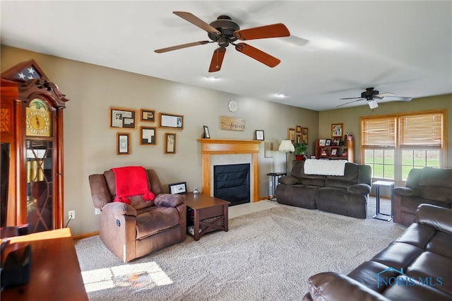 living room with a fireplace with flush hearth, carpet flooring, and a ceiling fan