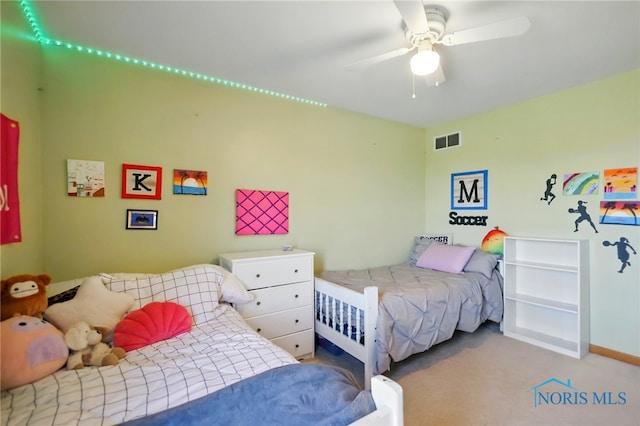 carpeted bedroom featuring baseboards, visible vents, and ceiling fan