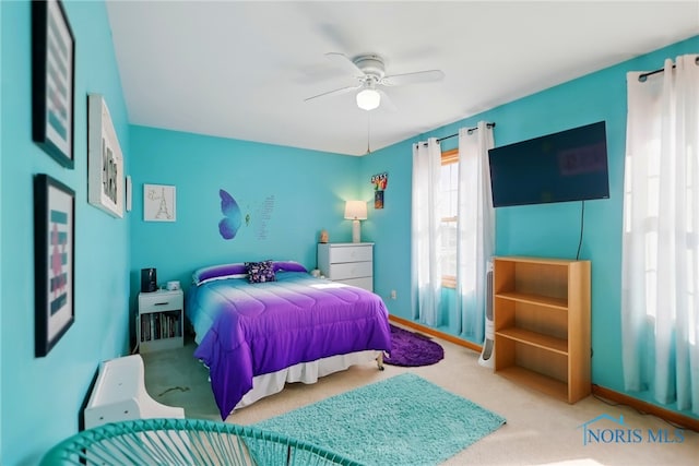 bedroom with a ceiling fan and carpet