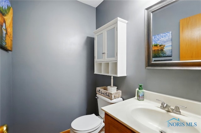 half bathroom featuring toilet and vanity