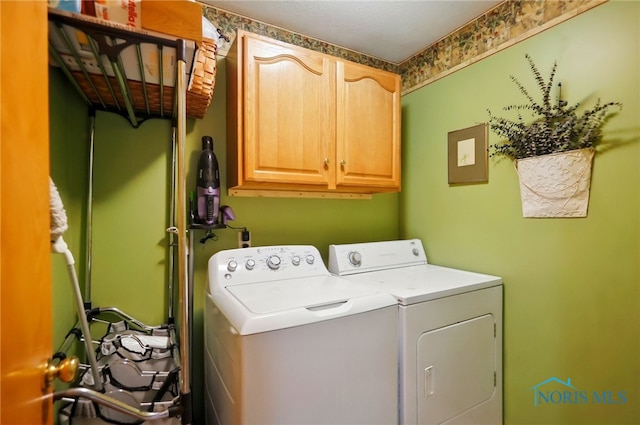 laundry area with cabinet space and separate washer and dryer