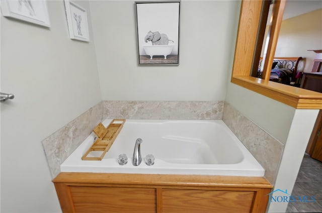 full bath featuring a bath and tile patterned floors