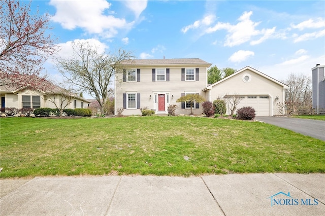 1605 Eaglecrest Rd, Perrysburg, OH 43551 - colonial-style house with entry steps, driveway, a garage, and a front yard