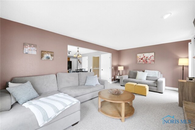 1605 Eaglecrest Rd, Perrysburg, OH 43551 - carpeted living room with a chandelier and baseboards