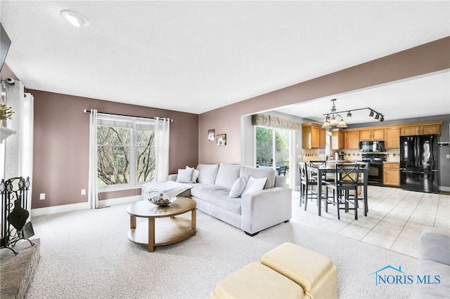 1605 Eaglecrest Rd, Perrysburg, OH 43551 - living area featuring track lighting, baseboards, and a chandelier