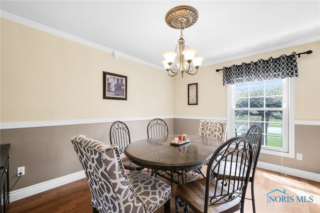 1605 Eaglecrest Rd, Perrysburg, OH 43551 - dining room with crown molding, baseboards, an inviting chandelier, and wood finished floors