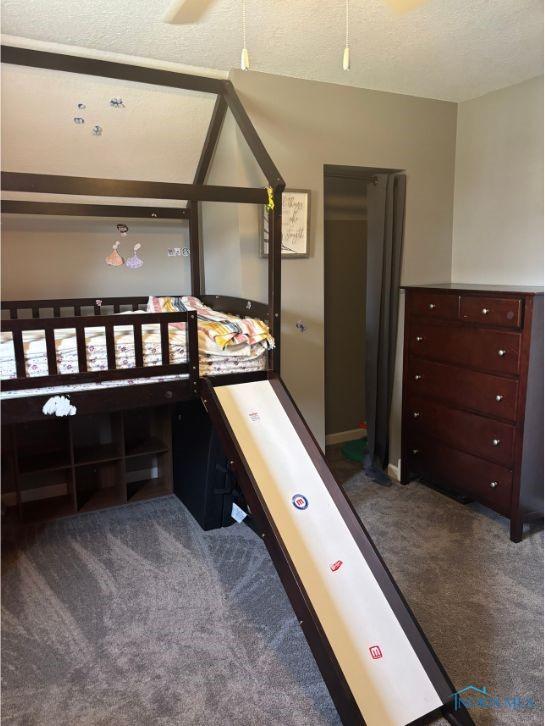 carpeted bedroom featuring a textured ceiling