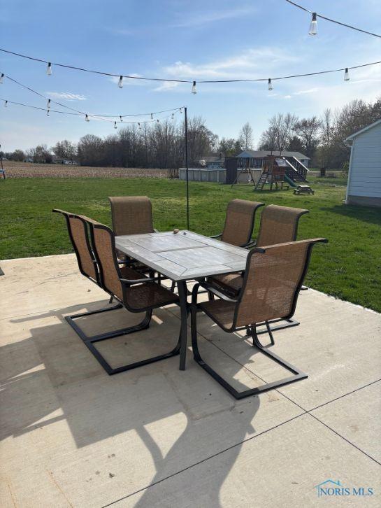 view of patio featuring a playground and outdoor dining area