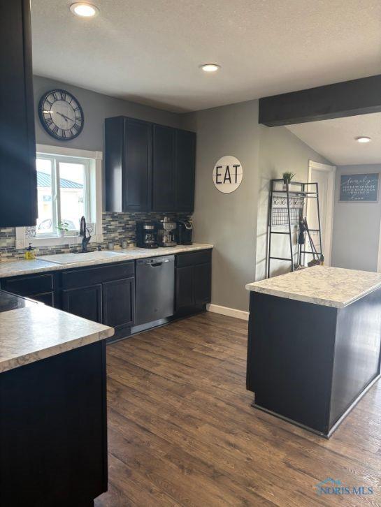 kitchen with decorative backsplash, stainless steel dishwasher, light countertops, and recessed lighting