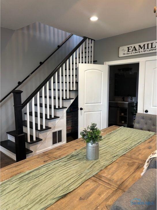 interior space featuring wood finished floors, recessed lighting, visible vents, and stairs