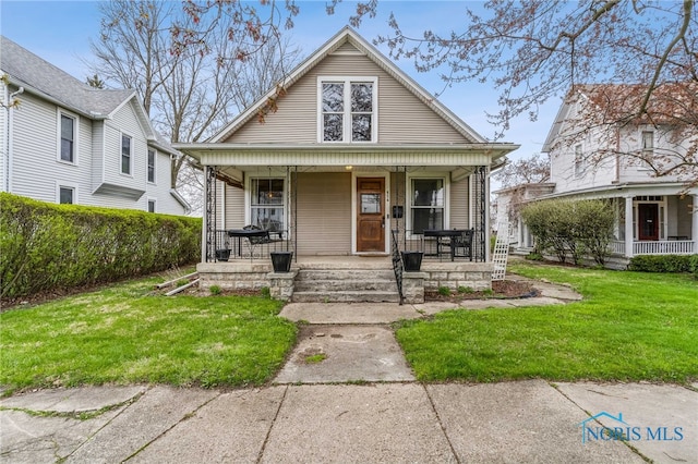 416 Cherry St, Findlay, OH 45840 - view of front of house featuring a porch and a front yard