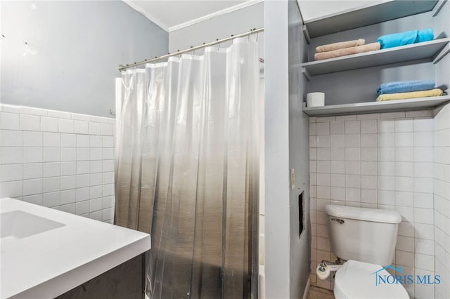 416 Cherry St, Findlay, OH 45840 - bathroom featuring tile walls, a shower with shower curtain, ornamental molding, and toilet