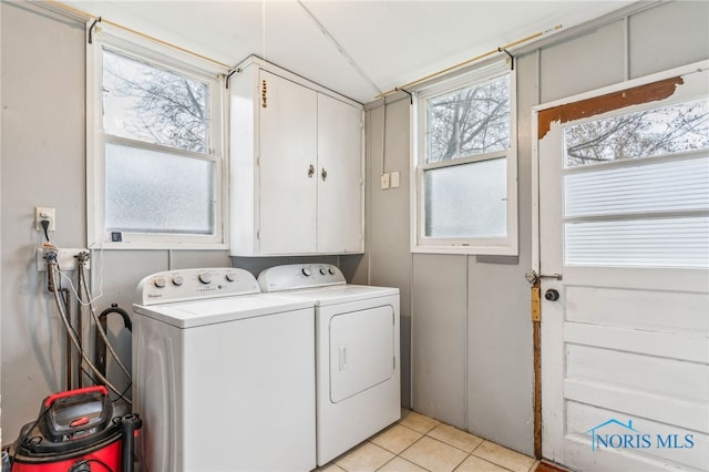 416 Cherry St, Findlay, OH 45840 - laundry area with light tile patterned floors, a wealth of natural light, cabinet space, and independent washer and dryer