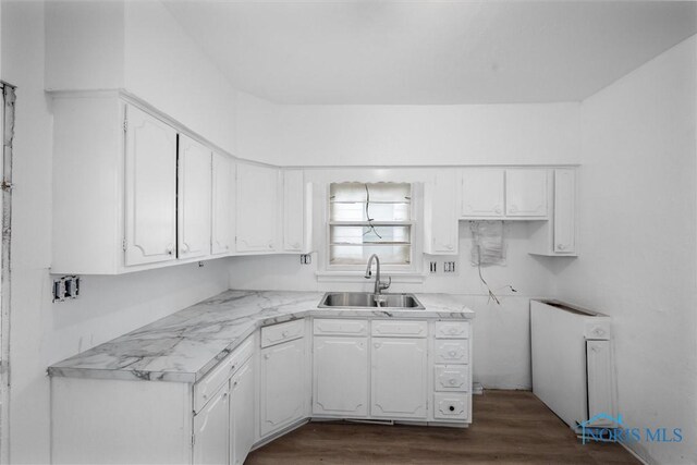 3251 Cottage Ave, Toledo, OH 43608 - kitchen with light countertops, dark wood-style flooring, white cabinetry, and a sink