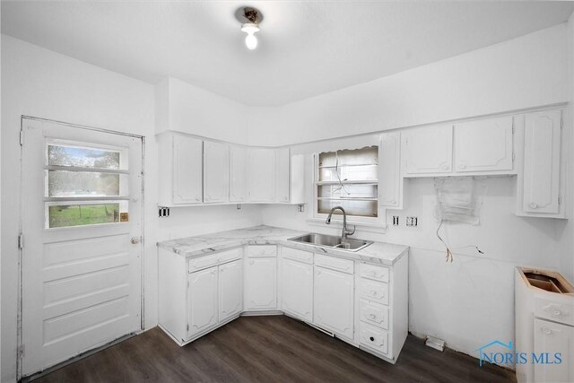 3251 Cottage Ave, Toledo, OH 43608 - kitchen with light countertops, dark wood-style floors, white cabinetry, and a sink