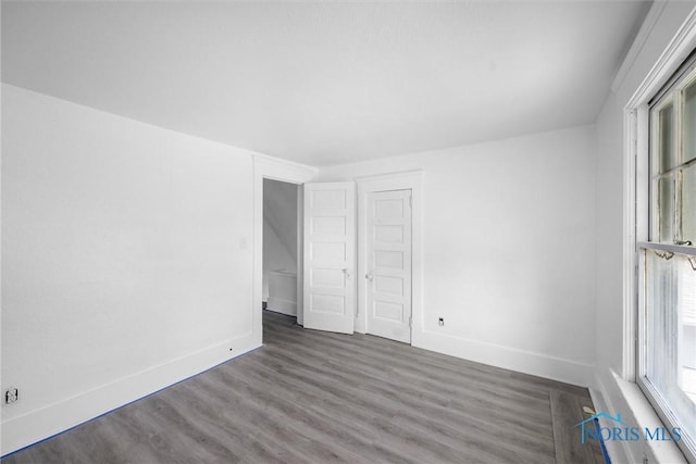 3251 Cottage Ave, Toledo, OH 43608 - unfurnished bedroom with wood finished floors, a closet, and baseboards