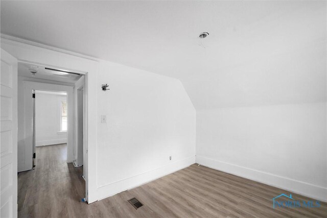 3251 Cottage Ave, Toledo, OH 43608 - additional living space featuring vaulted ceiling, baseboards, wood finished floors, and visible vents
