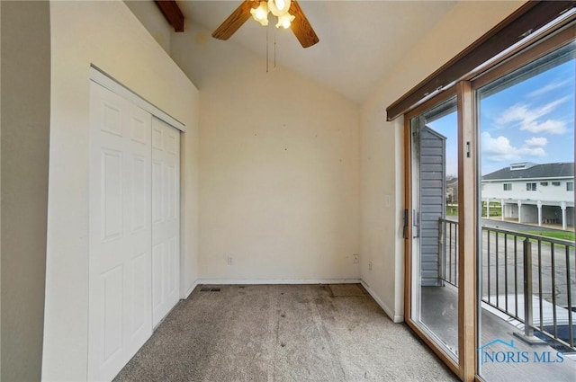 unfurnished bedroom with access to outside, a closet, baseboards, carpet flooring, and lofted ceiling