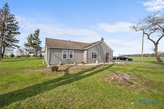 exterior space with a chimney and a front yard
