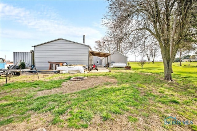 view of yard with an outdoor fire pit
