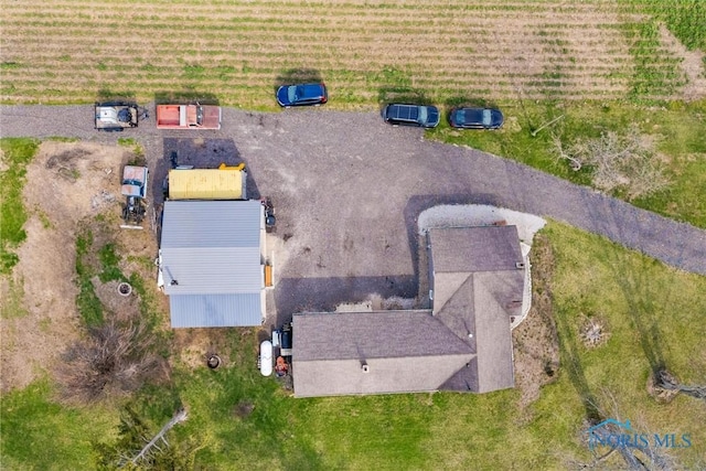 birds eye view of property with a rural view