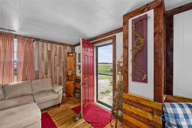 living room with wood walls and wood finished floors