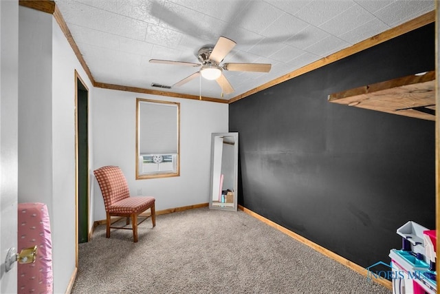 living area featuring visible vents, a ceiling fan, ornamental molding, baseboards, and carpet flooring