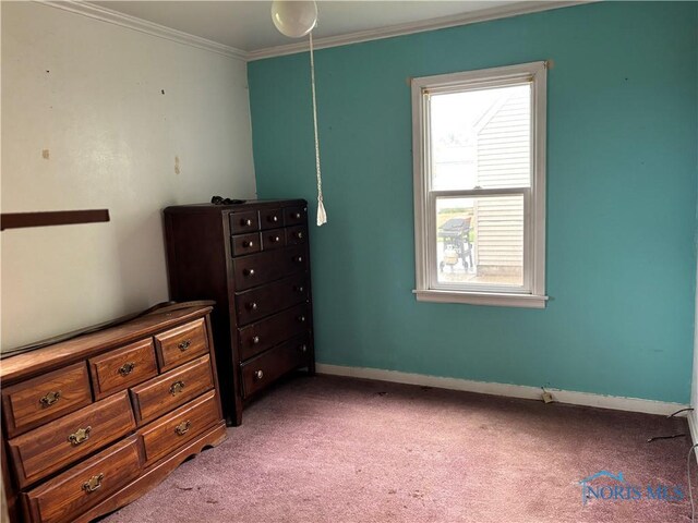 bedroom with crown molding, baseboards, and carpet flooring