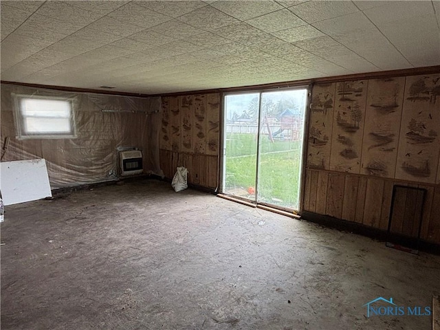 432 S Squire St, Holgate, OH 43527 - spare room featuring heating unit, a wood stove, and wood walls