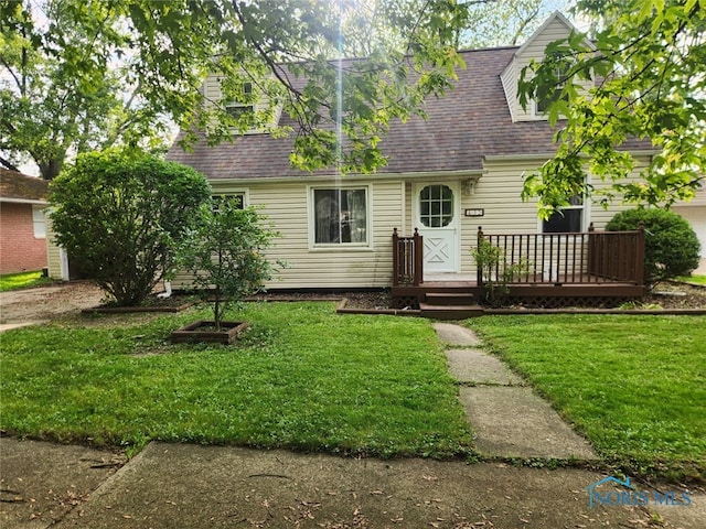432 S Squire St, Holgate, OH 43527 - new england style home featuring a wooden deck, a front yard, and a shingled roof