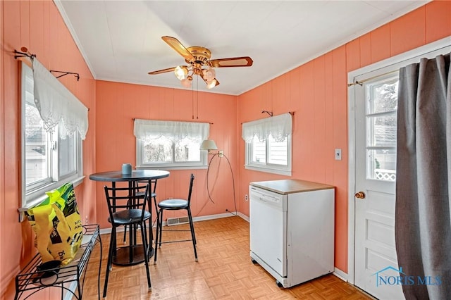 kitchen featuring ornamental molding, ceiling fan, fridge, and a wealth of natural light