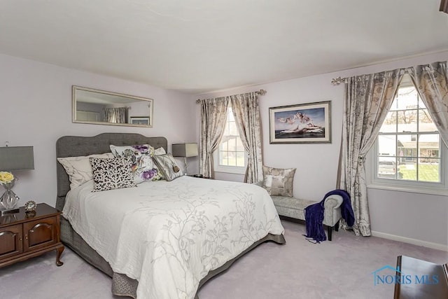 bedroom with baseboards and carpet