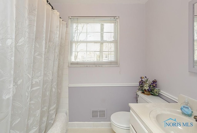 bathroom with shower / bath combination with curtain, visible vents, vanity, and toilet