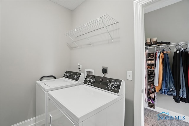 clothes washing area featuring washing machine and dryer, baseboards, carpet floors, and laundry area