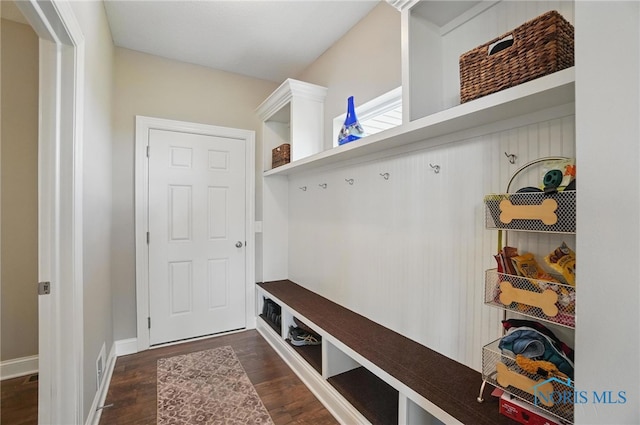 mudroom featuring baseboards and dark wood-style floors