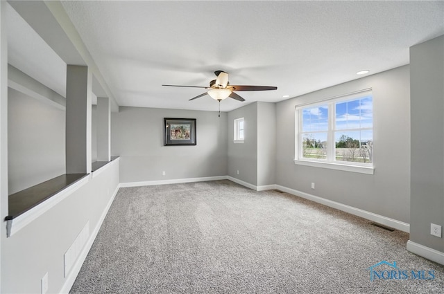 carpeted spare room featuring baseboards, visible vents, recessed lighting, and ceiling fan
