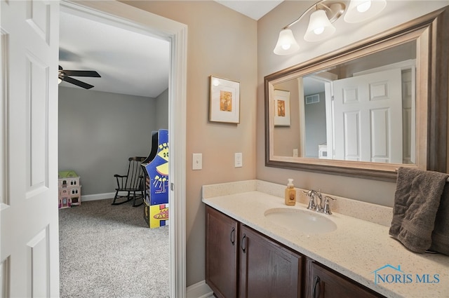 bathroom with baseboards, visible vents, a ceiling fan, and vanity