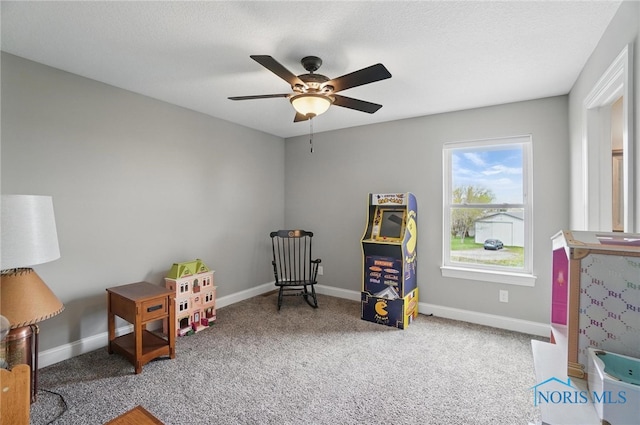 playroom with baseboards, a ceiling fan, and carpet
