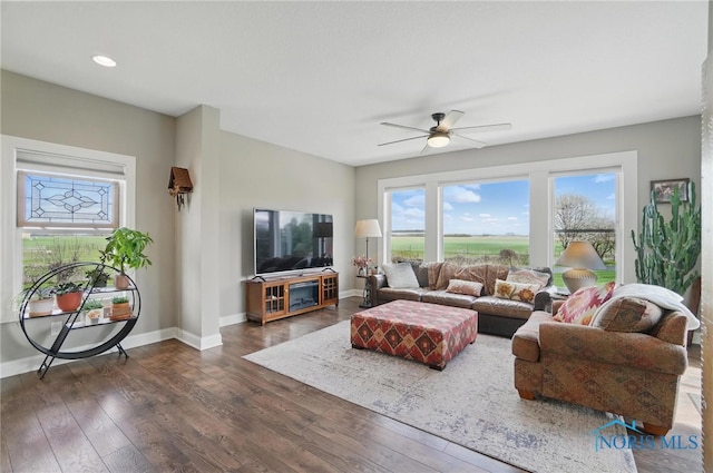 living area with a ceiling fan, baseboards, recessed lighting, and dark wood-type flooring