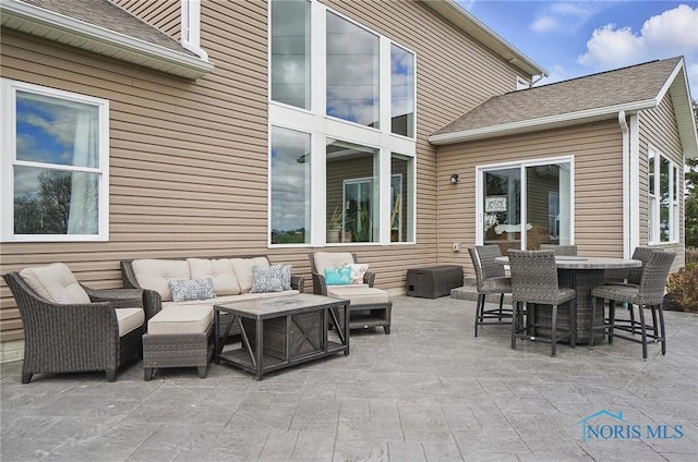 view of patio / terrace with outdoor dining space and an outdoor hangout area