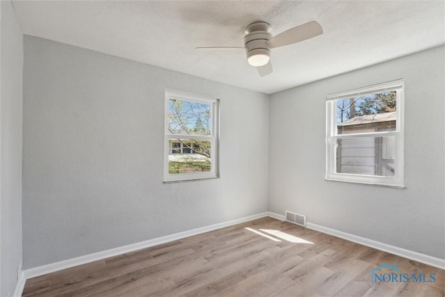 3105 W Laskey Rd, Toledo, OH 43613 - spare room featuring ceiling fan, wood finished floors, visible vents, and plenty of natural light