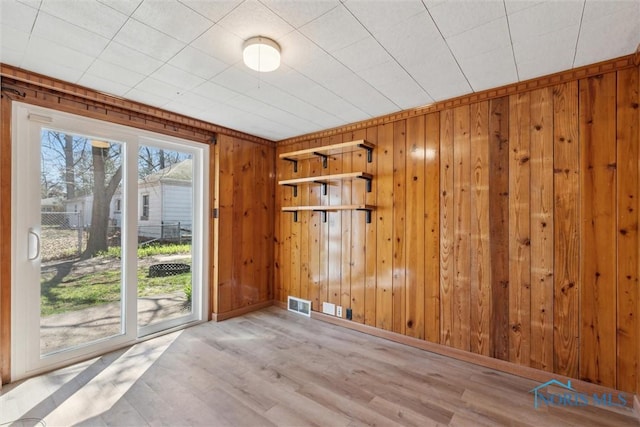 3105 W Laskey Rd, Toledo, OH 43613 - spare room with visible vents, baseboards, wooden walls, and wood finished floors
