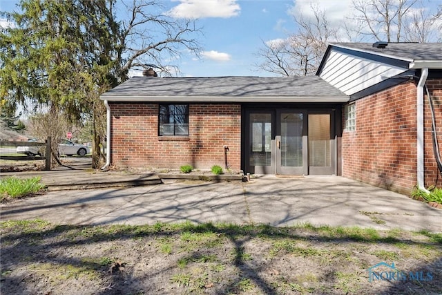 3105 W Laskey Rd, Toledo, OH 43613 - rear view of property with brick siding, french doors, a chimney, and a patio