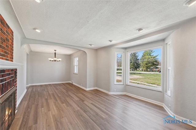 3105 W Laskey Rd, Toledo, OH 43613 - interior space with wood finished floors, a textured ceiling, baseboards, and an inviting chandelier