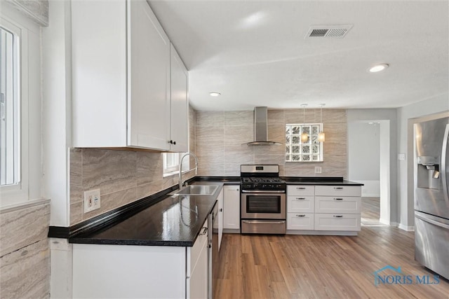 3105 W Laskey Rd, Toledo, OH 43613 - kitchen with wall chimney range hood, tasteful backsplash, dark countertops, a sink, and stainless steel appliances