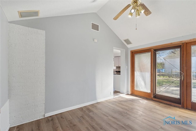 3105 W Laskey Rd, Toledo, OH 43613 - unfurnished living room with wood finished floors, visible vents, high vaulted ceiling, and a ceiling fan