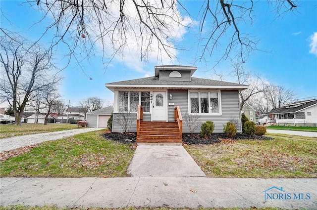 221 S Cherry St, Paulding, OH 45879 - bungalow-style house with a front lawn and a garage